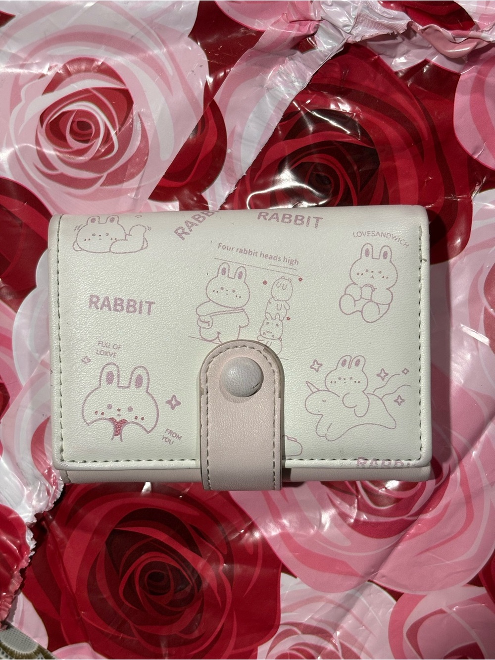 Adorable rabbit-print kids wallet in light pink and white. Durable faux leather